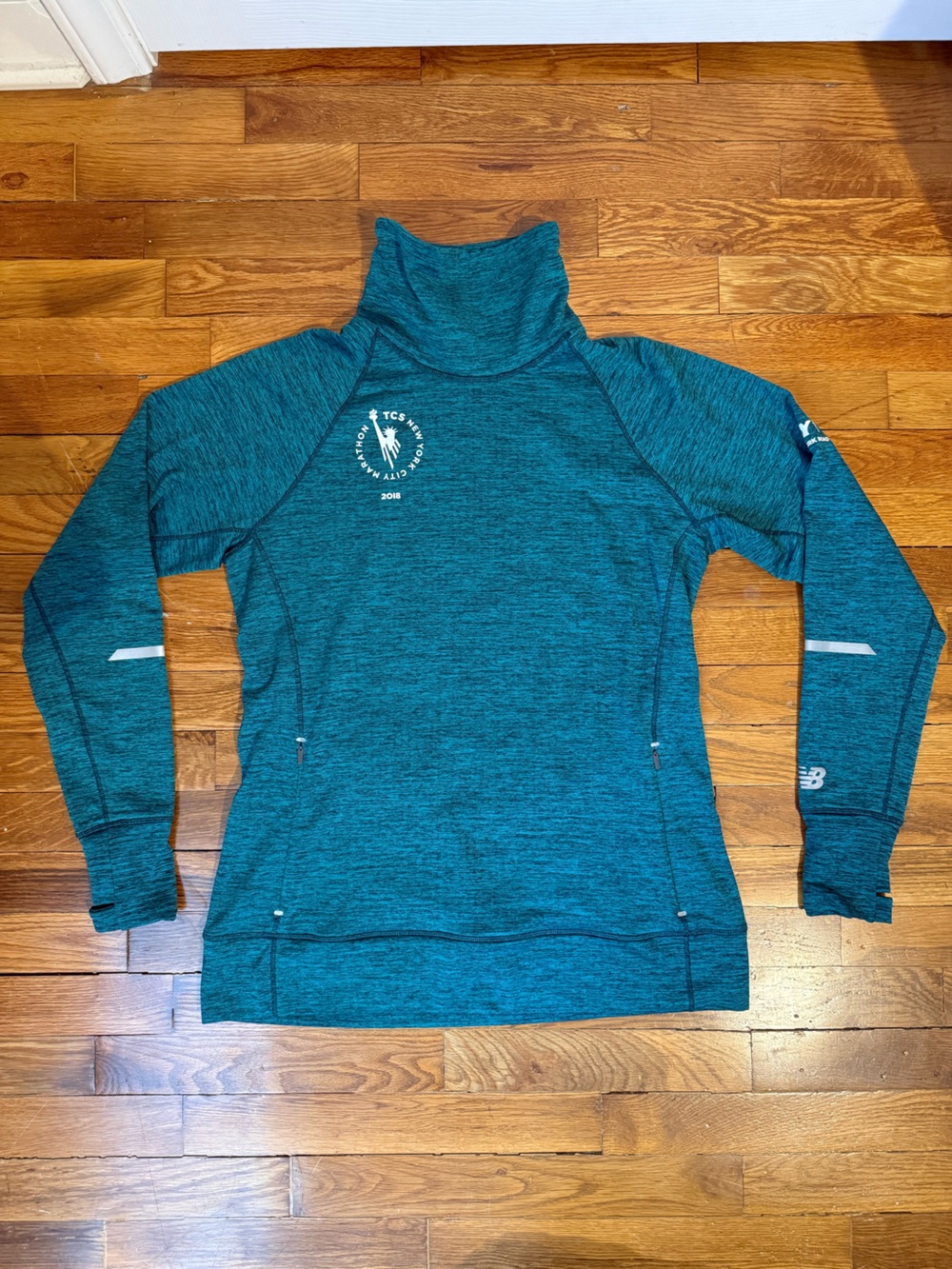 Woman’s New Balance Teal Marathon Performance Pullover Sweater